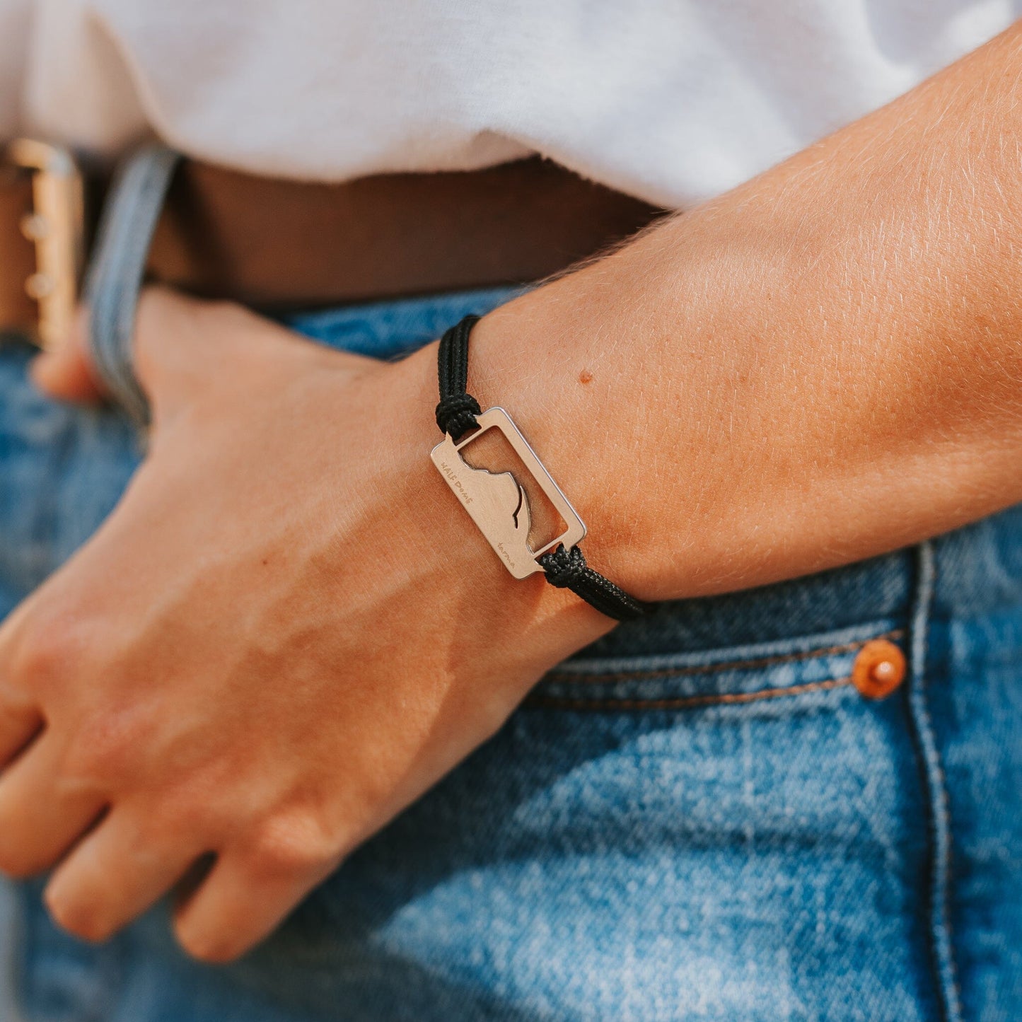 Women wearing stainless steel half dome yosemite pendant bracelet on black paracord