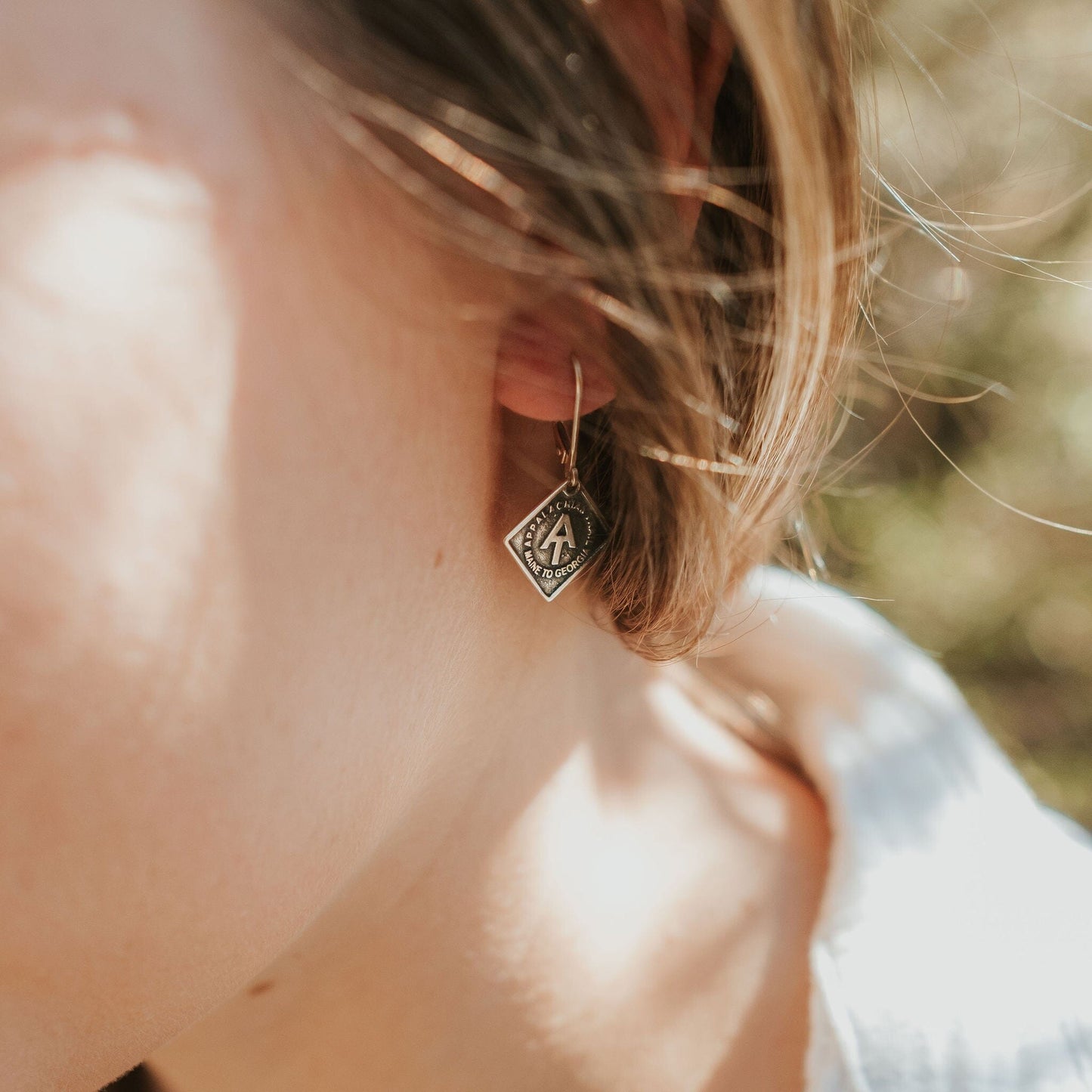 Girl wearing sterling silver appalachian trail earrings