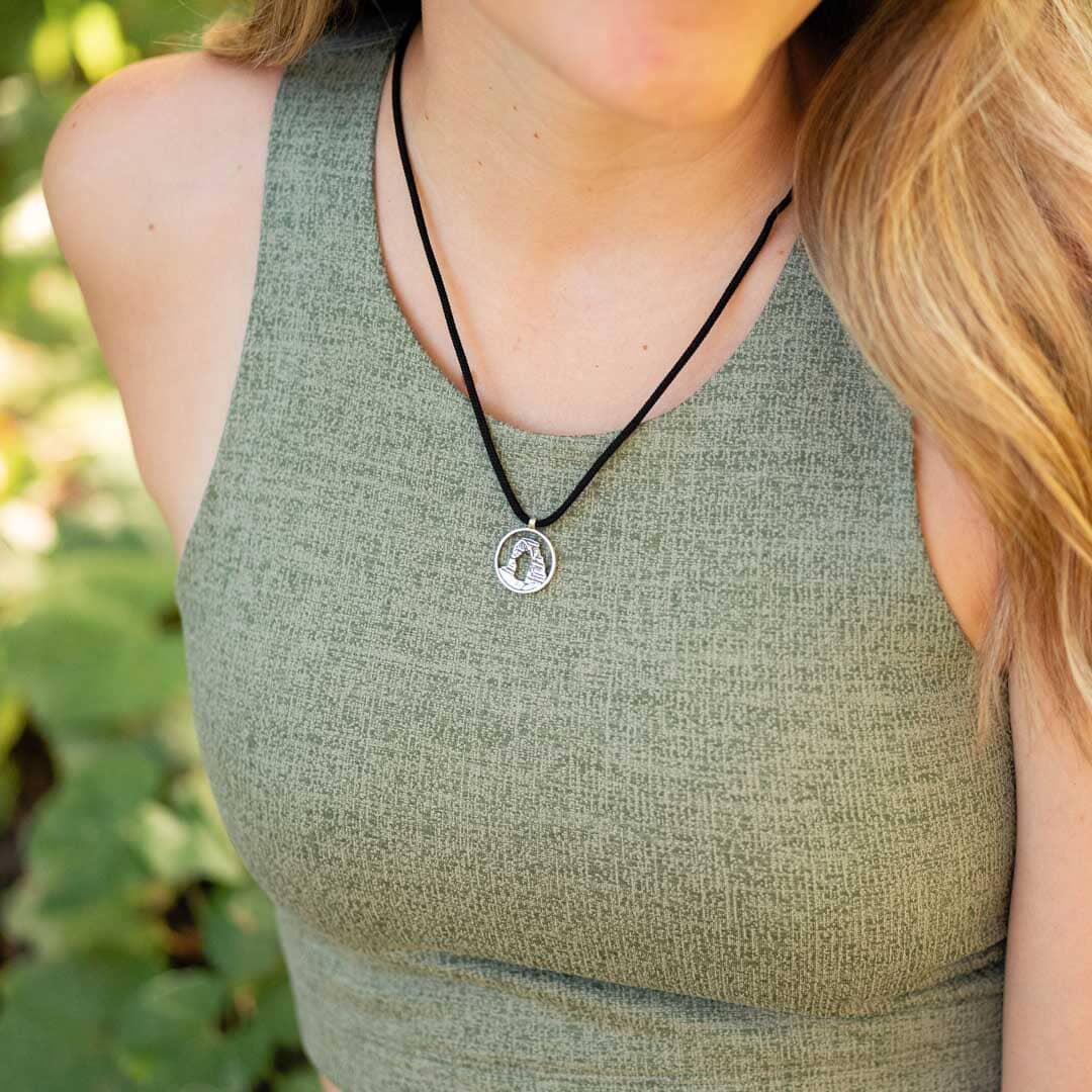 Women wearing delicate arch pendant on black paracord