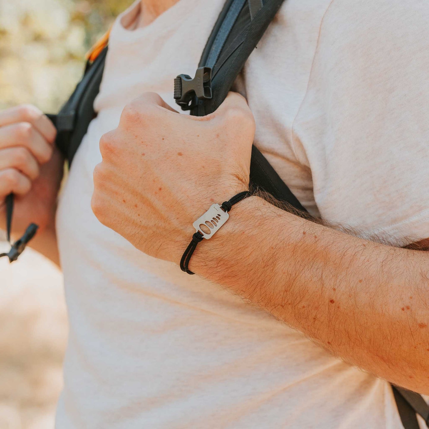 Man wearing stainless steel cairn bracelet