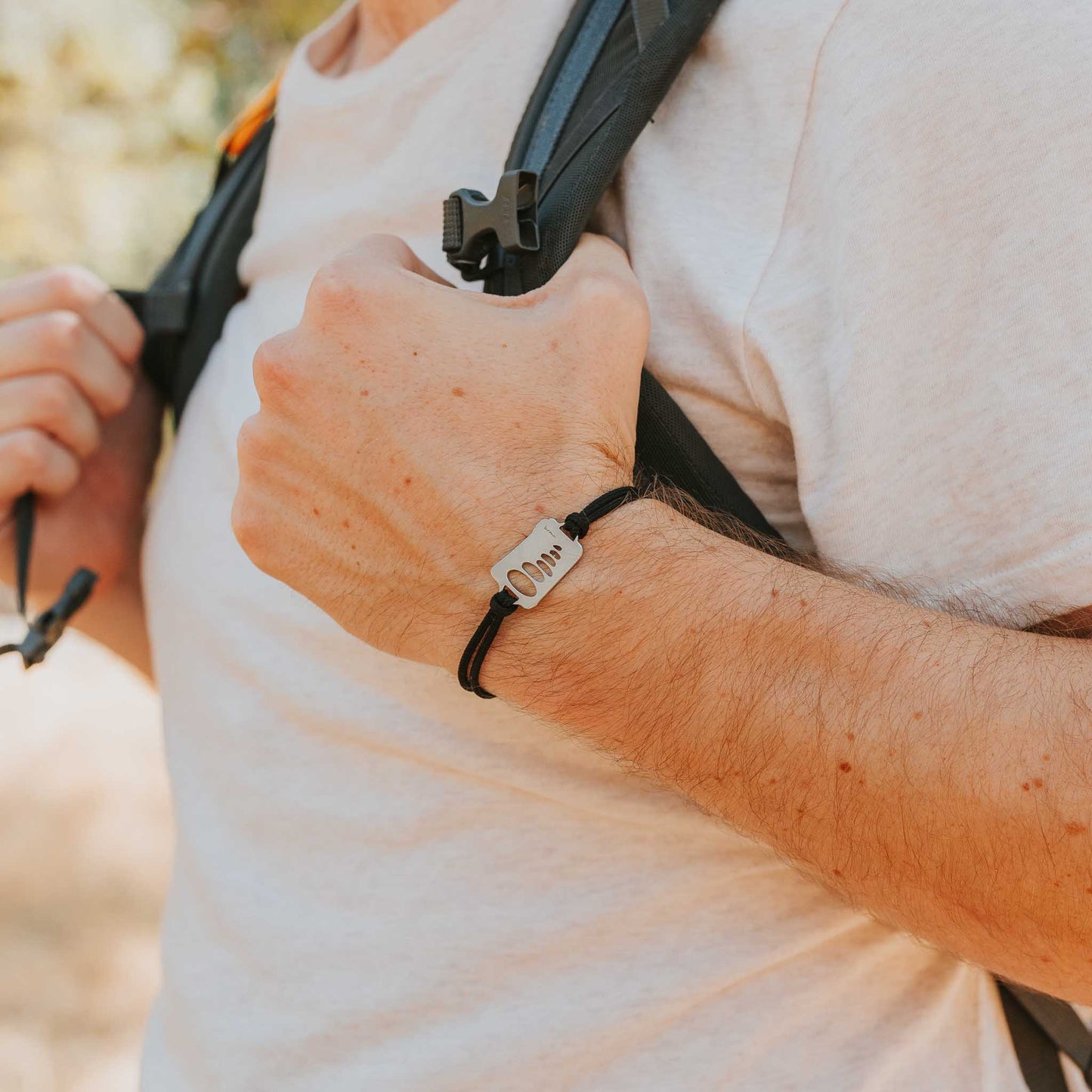 Man wearing stainless steel cairn bracelet 