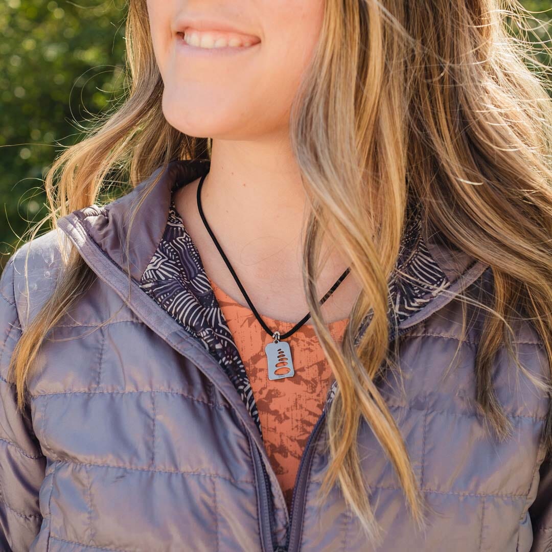 Women wearing stainless steel cairn stacked stones pendant on black paracord