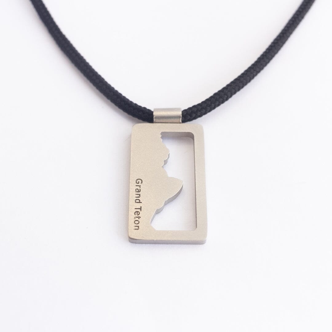 Stainless steel grand teton national park pendant on black paracord