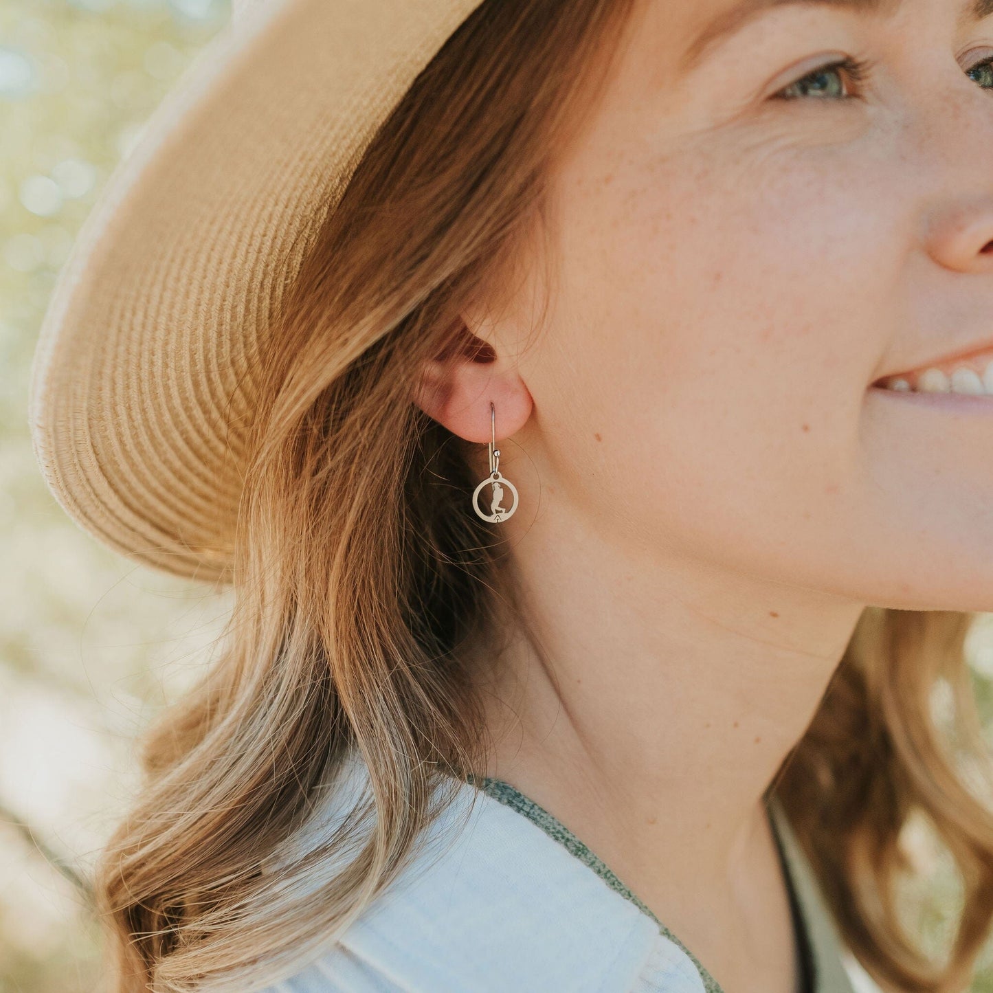 Girl wearing stainless steel hiking girl earrings