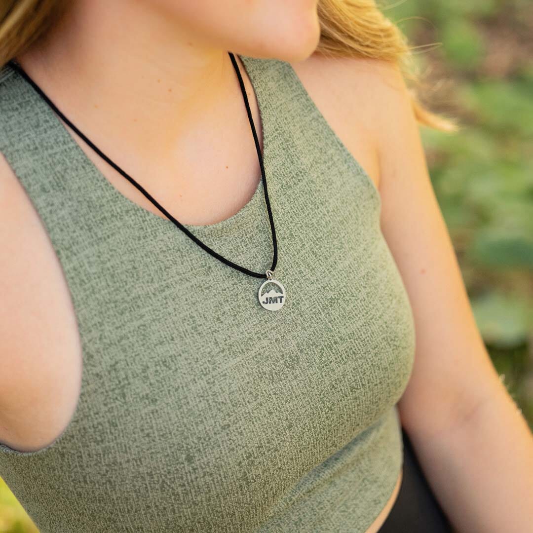 Women wearing stainless steel john muir trail pendant on black paracord
