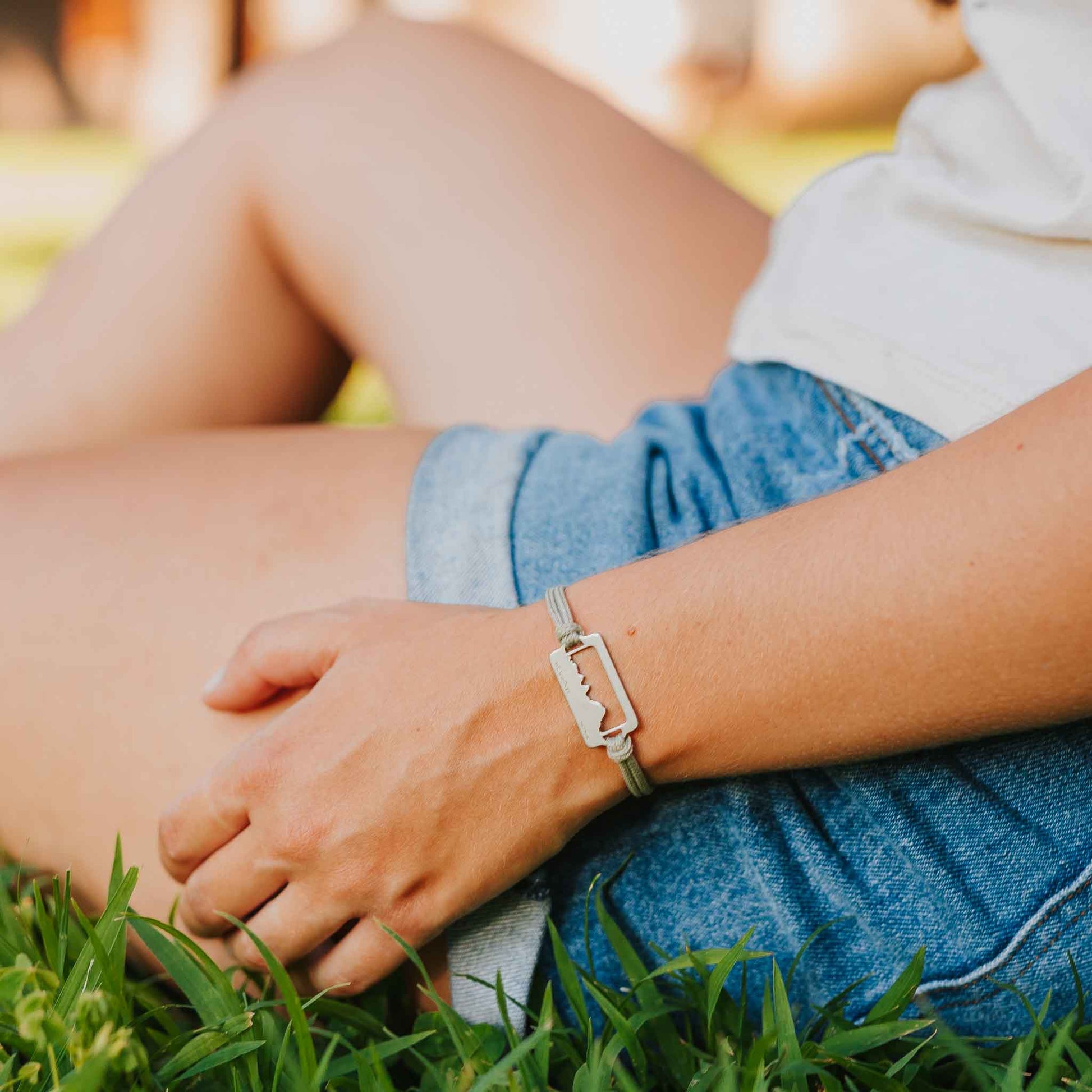 Women wearing stainless steel mount whitney bracelet on slate paracord