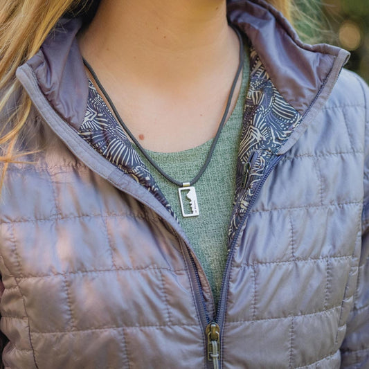 Women wearing stainless steel mount whitney pendant on black paracord