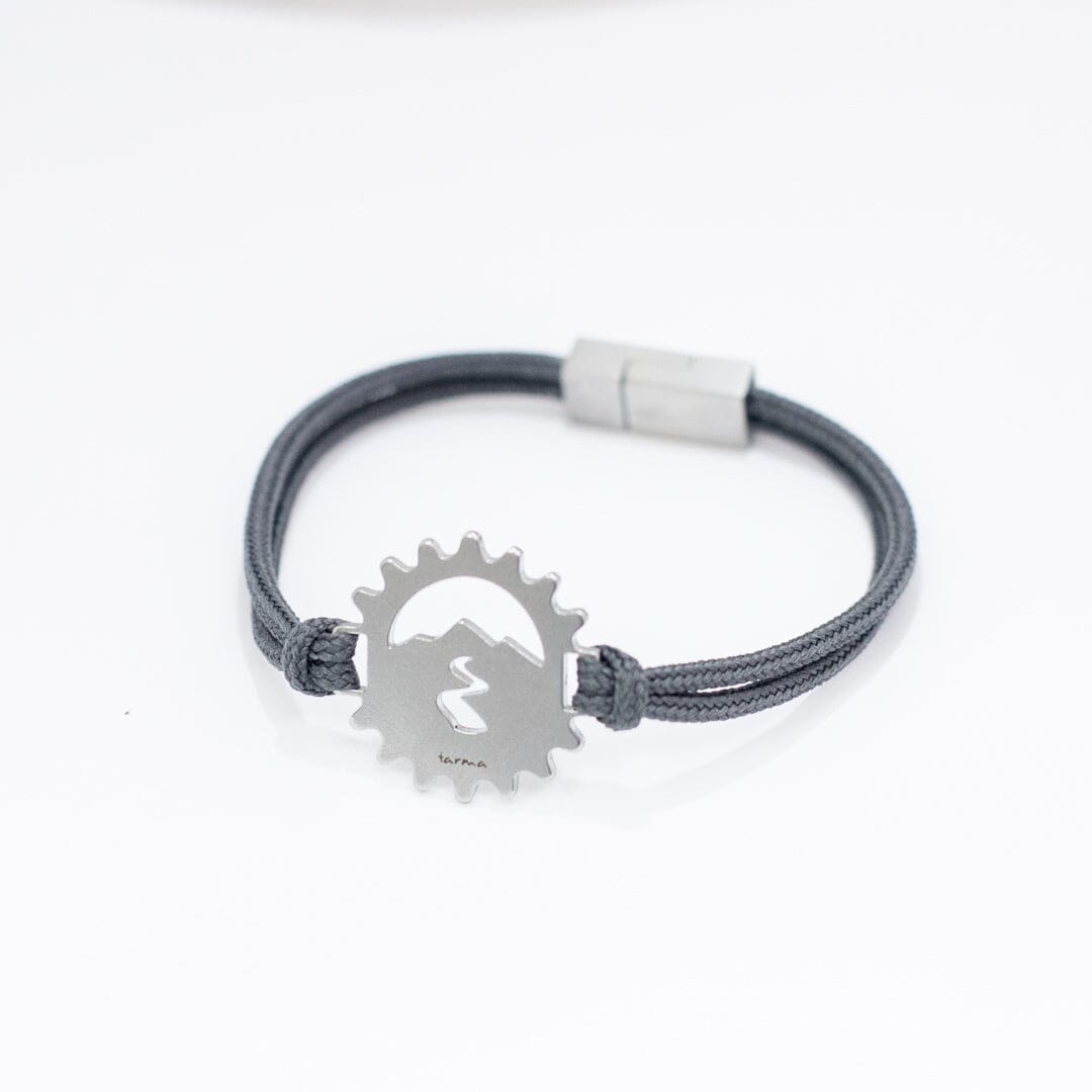 Stainless steel bicycle cog bracelet on slate paracord