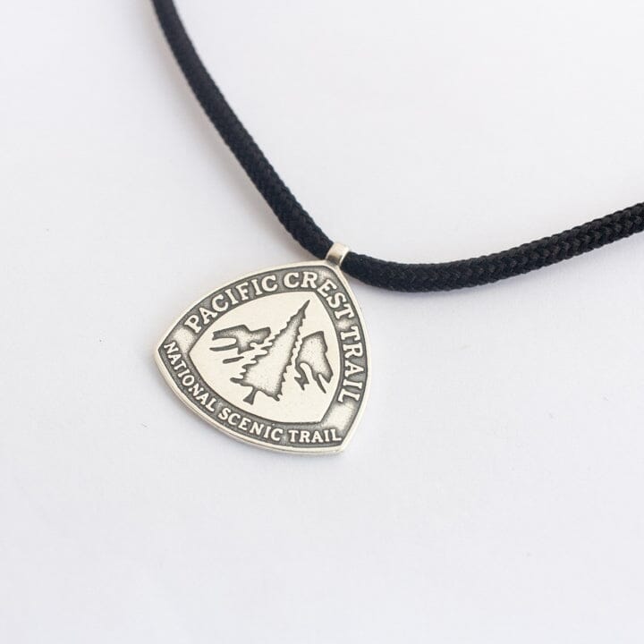 White Bronze pacific crest trail marker pendant on black paracord