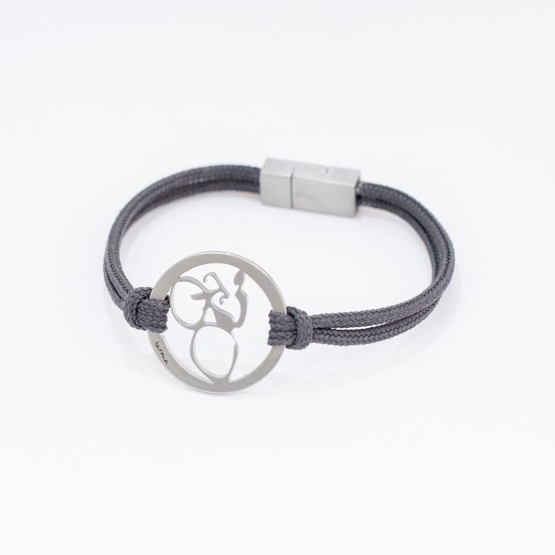 Stainless steel road bike bracelet on slate paracord