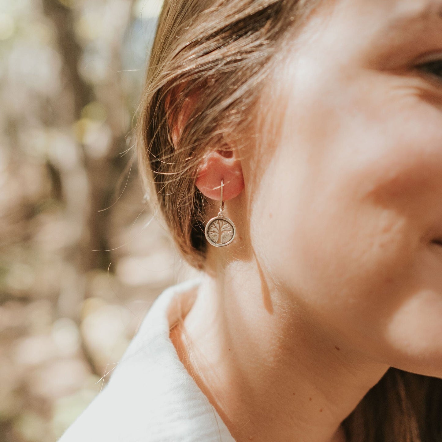 Girl wearing tree of life earrings in sterling silver 