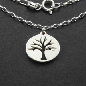 Sterling silver tree charm necklace pendant and chain on dark background
