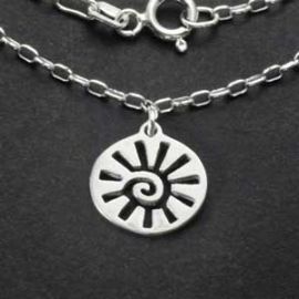 Close-up of the sterling silver sun charm pendant with spiral center