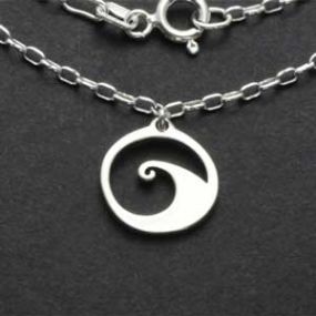 Sterling silver wave charm pendant close-up on dark background