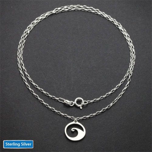 Sterling silver wave charm necklace full length on dark background