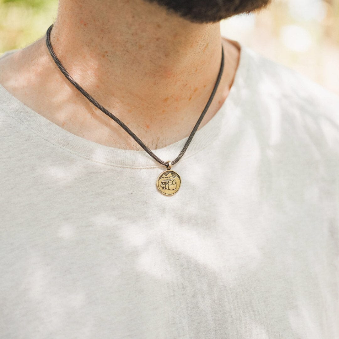 man wearing bronze airstream camper van necklace with slate polycord
