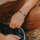 Man wearing stainless steel appalachian trail blaze marker bracelet