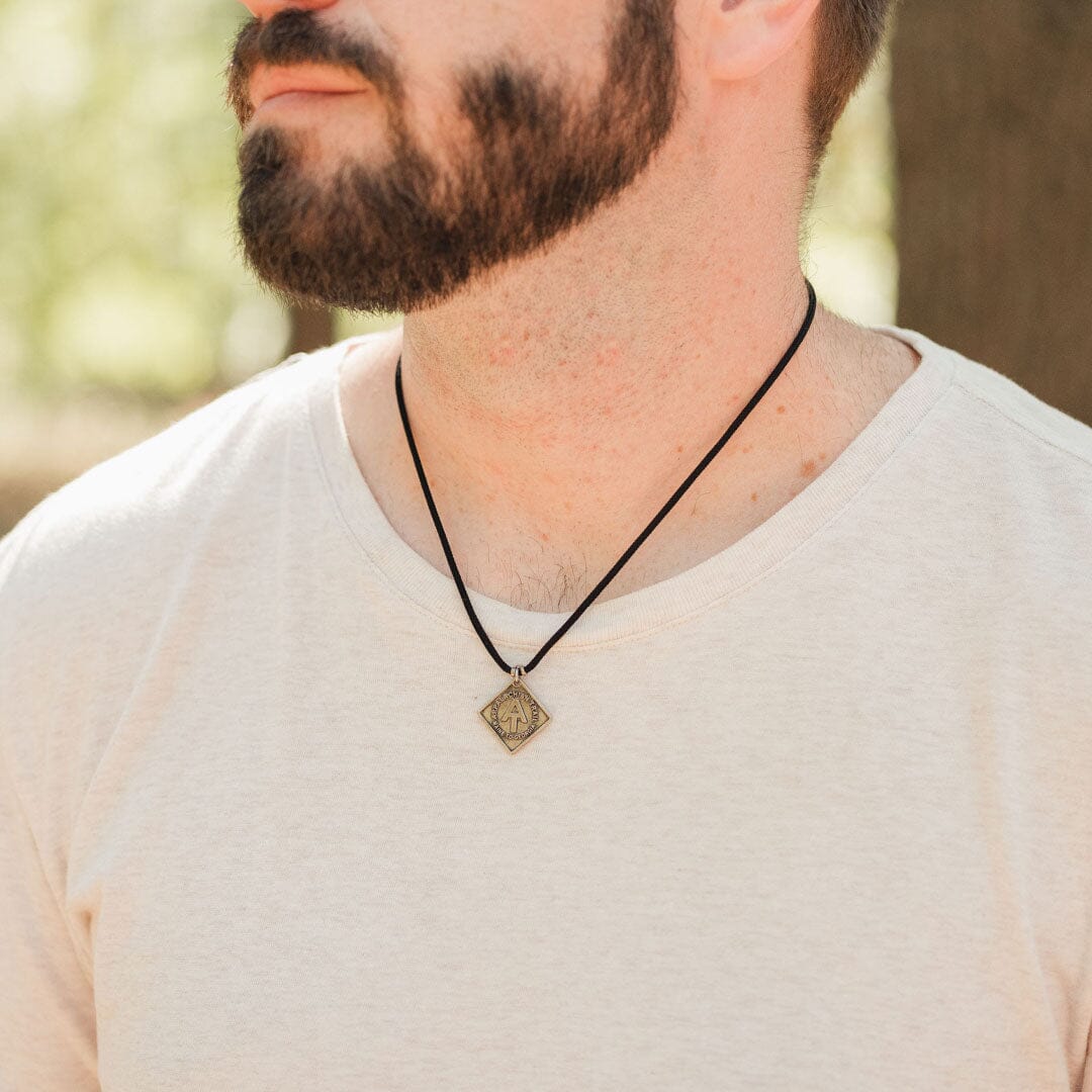 man wearing appalachian trail logo necklace in black paracord