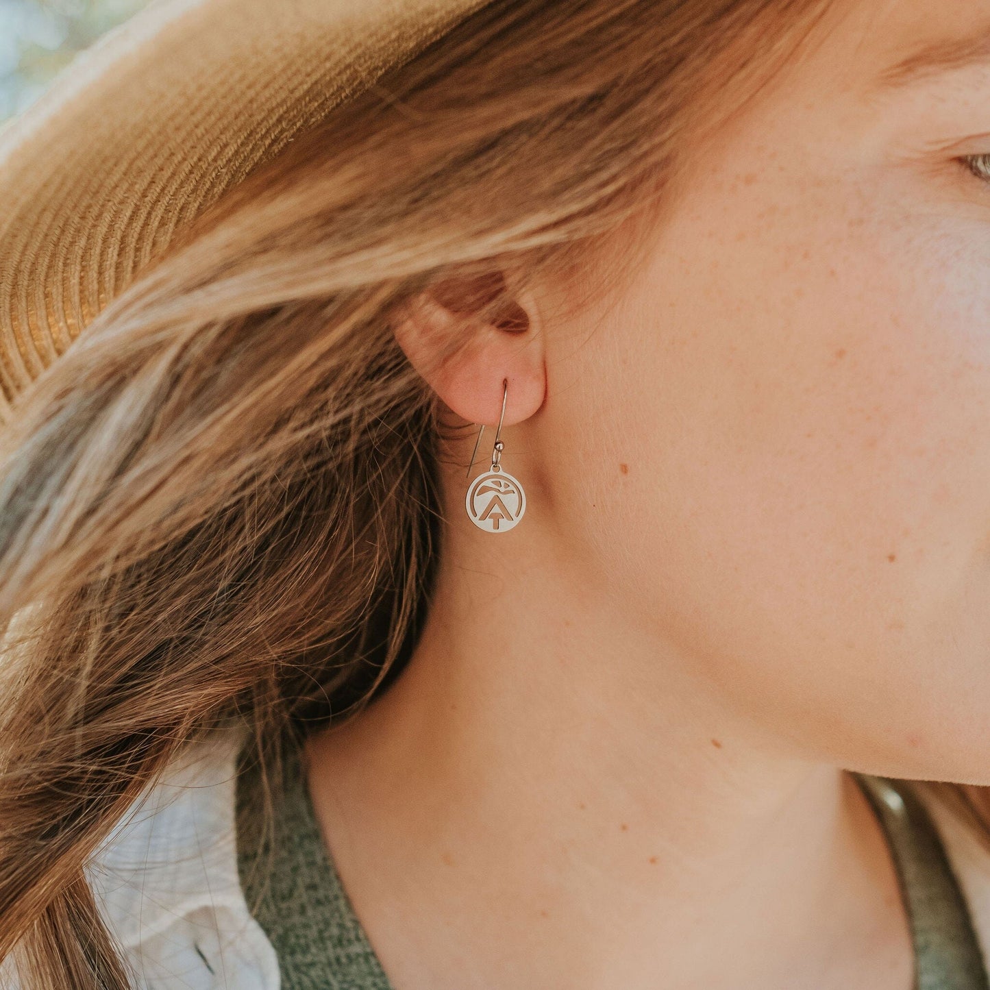Girl wearing stainless steel appalachian trail sun earrings