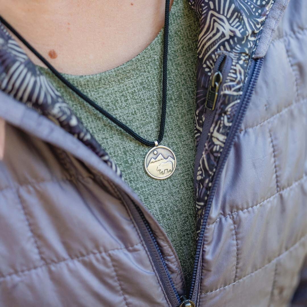 Women wearing sterling silver bear pendant on black paracord