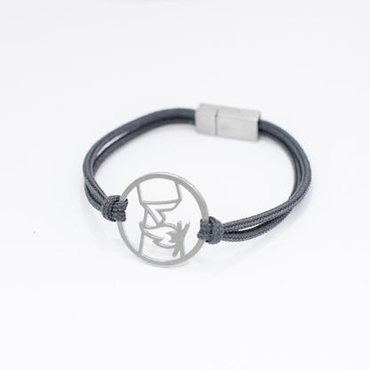 Stainless steel campfire and tent pendant bracelet on slate paracord