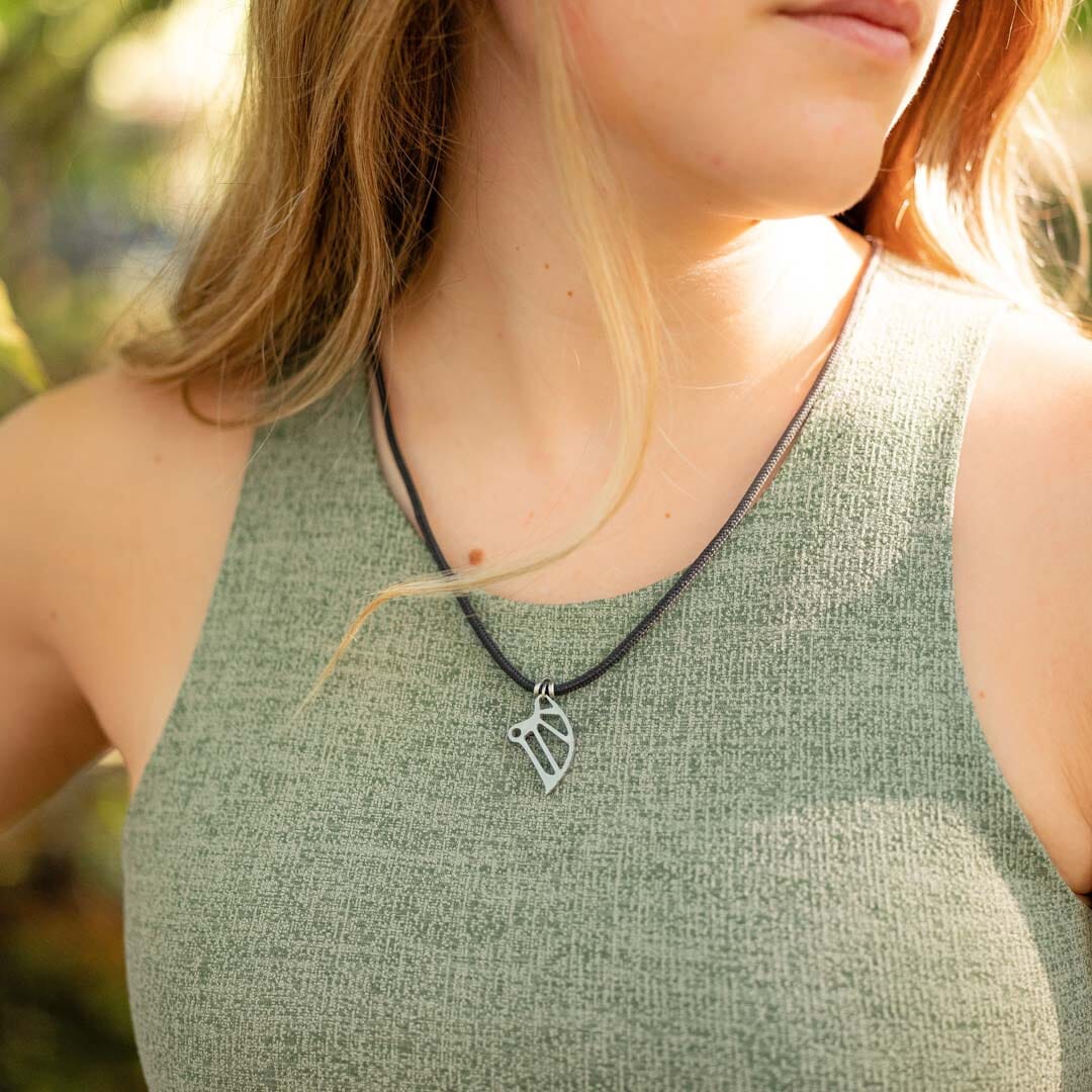 Women wearing stainless steel climbing cam pendant on black paracord