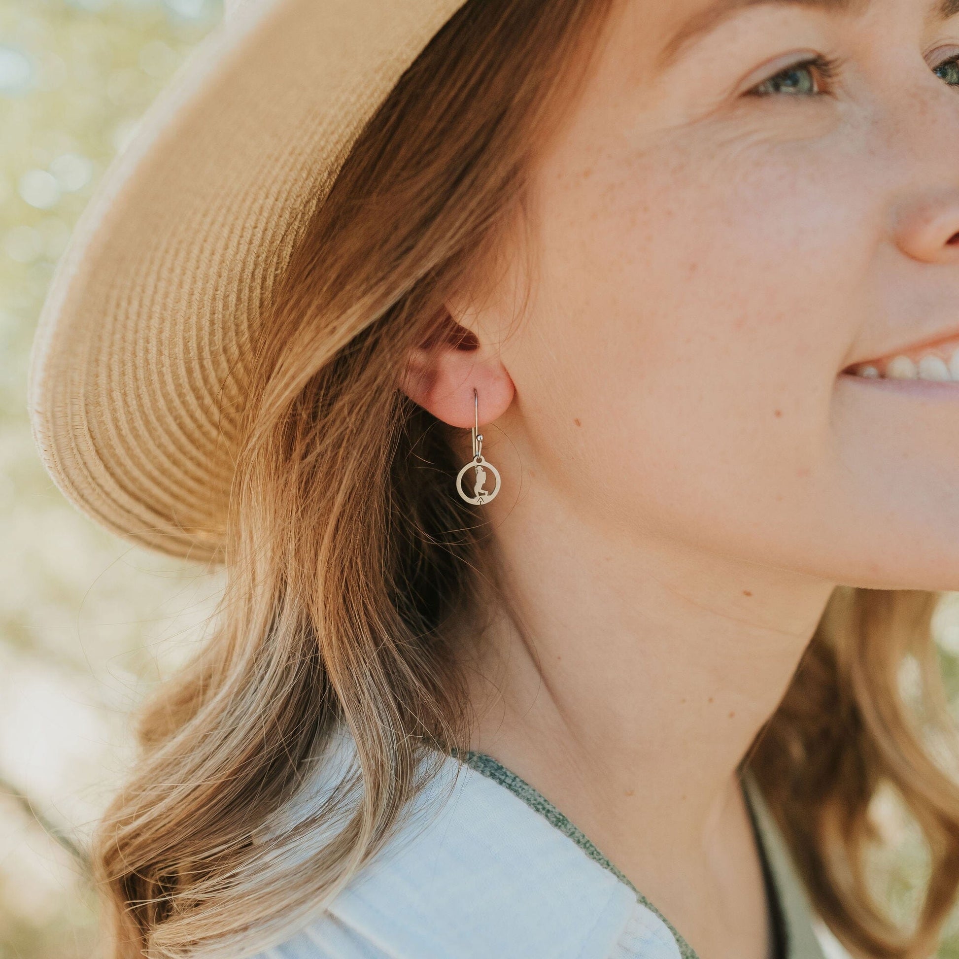Girl wearing stainless steel hiking girl earrings 