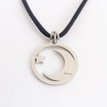 Stainless steel moon and star pendant on black paracord