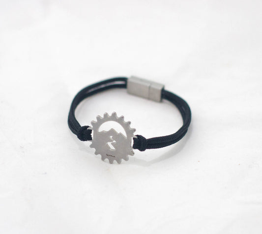 Stainless steel bicycle cog bracelet on black paracord