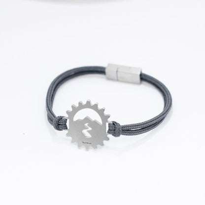 Stainless steel bicycle cog bracelet on slate paracord