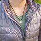 Women wearing sterling silver mountain necklace on black paracord