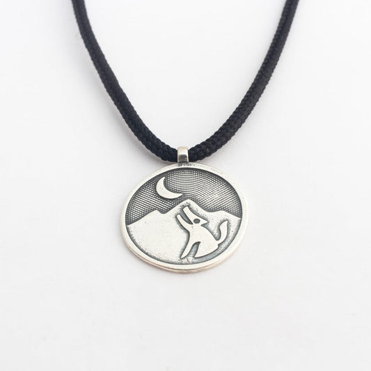 Sterling silver coyote pendant on black paracord