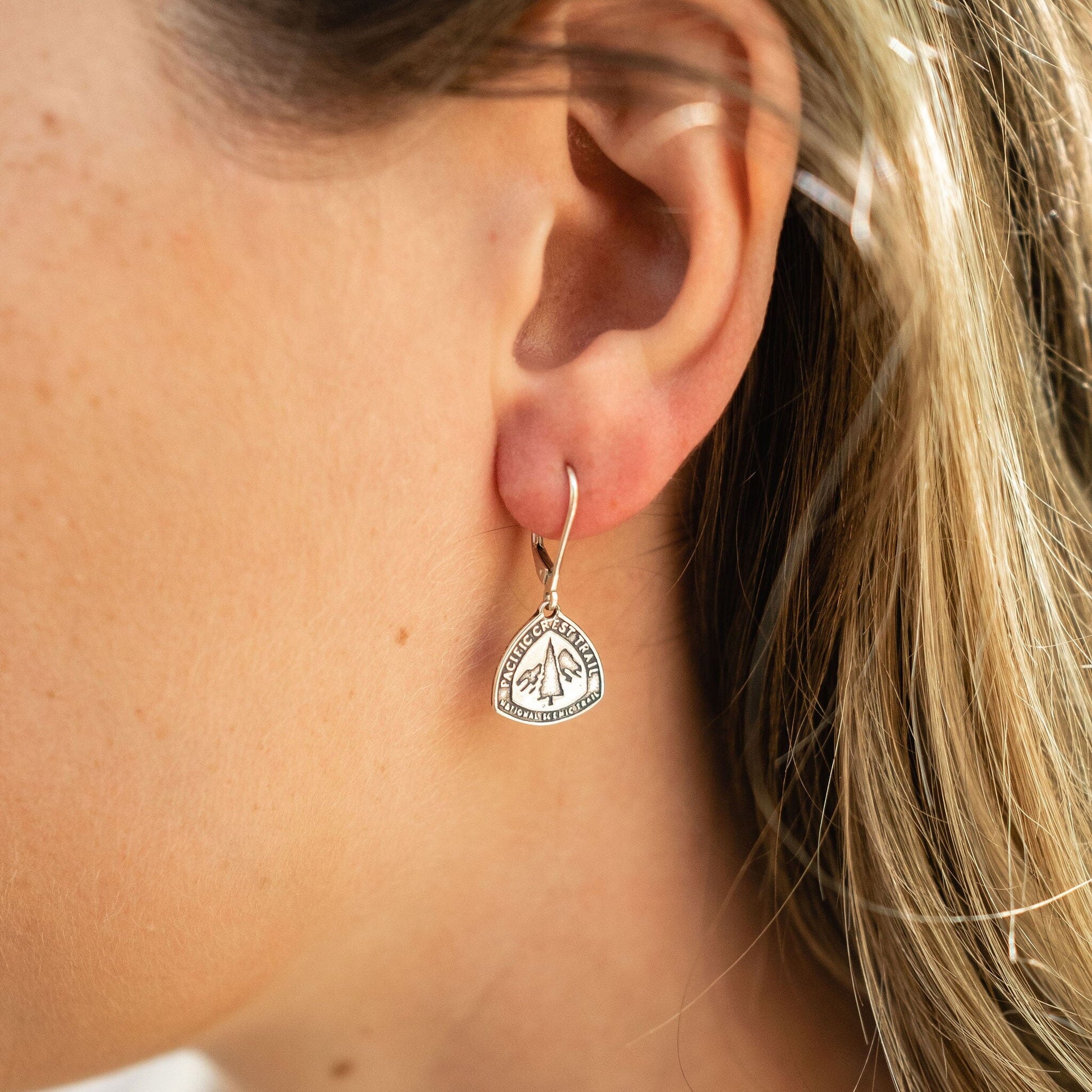 Girl wearing pacific crest trail earrings in sterling silver