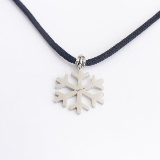 Stainless steel snowflake pendant on black paracord
