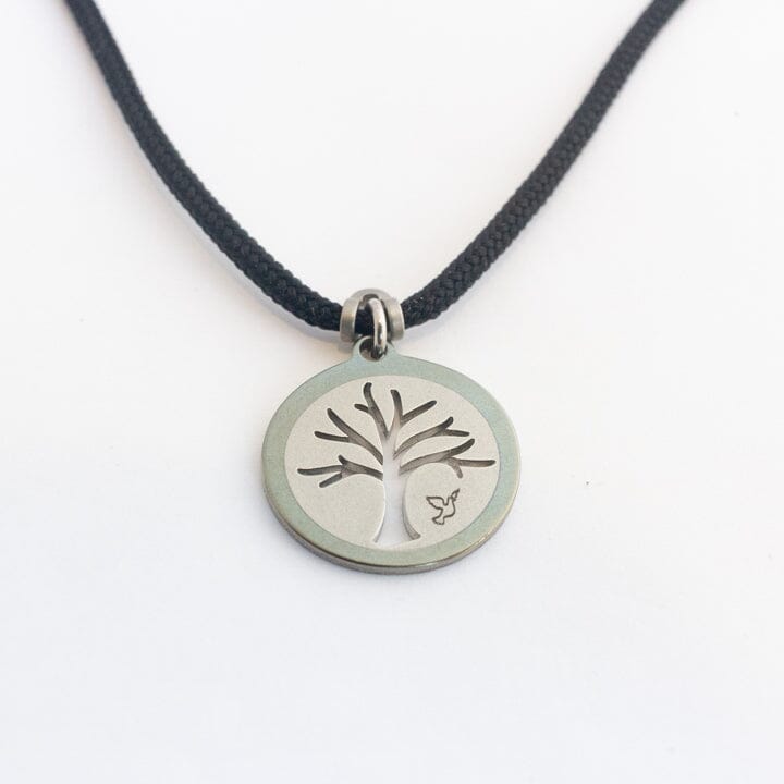 Stainless steel tree of life pendant on black paracord