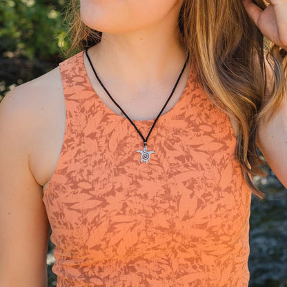 Women wearing stainless steel turtle pendant on black paracord