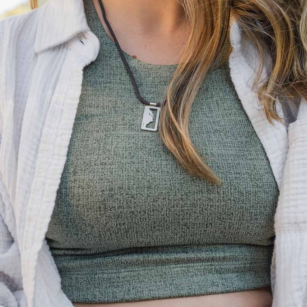 Women wearing stainless steel half dome pendant on black paracord