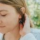 Girl wearing zen circle earrings in stainless steel